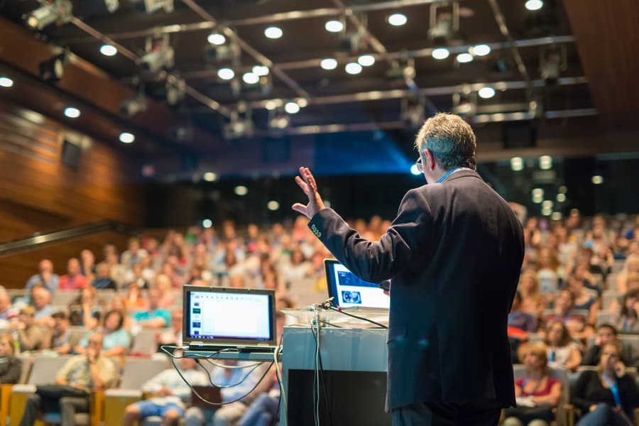 presenter using a semi custom multimedia podium in a lecture hall